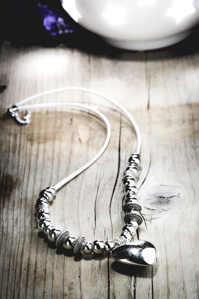 elegant silver necklace, clean modern upscale jewellery product photography